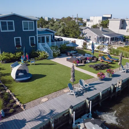a backyard with a pool and chairs