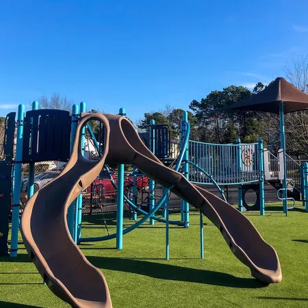 a person's hand on a playground