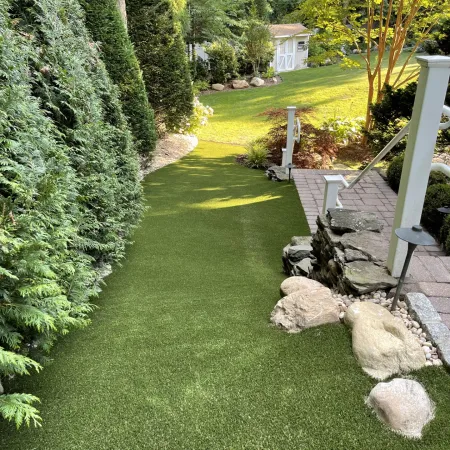 a yard with a stone wall and a stone fence