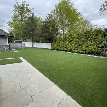 a backyard with a fence and a house