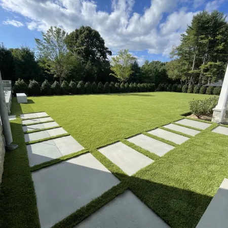 a large green lawn with white stones