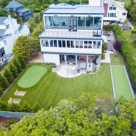 a large white house with a green lawn