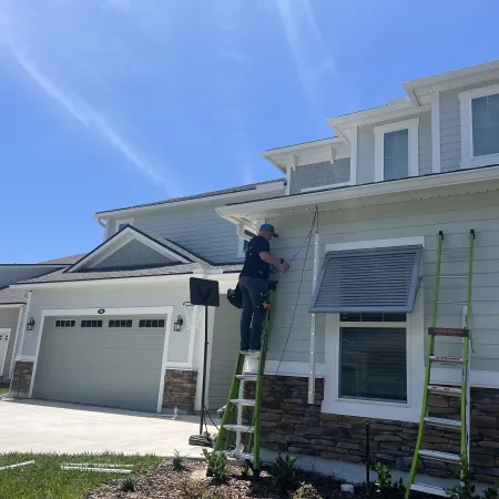 a person on a ladder painting a house