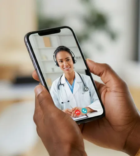 Doctor using tablet and stylus interacting with virtual health checklists and patient profiles with heart symbol.