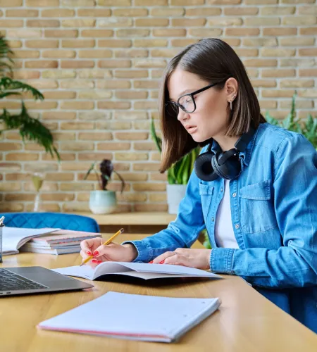a woman wearing headphones and sitting at a desk