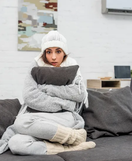 a person sitting on a couch cold in home