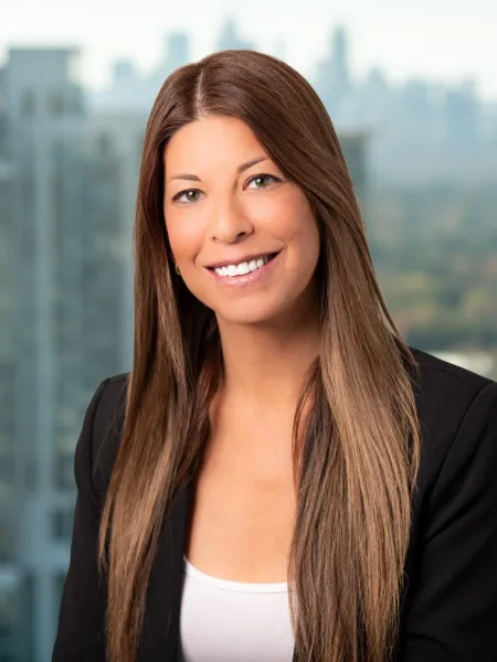 a woman smiling with a city in the background