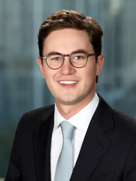 a man wearing glasses and a suit