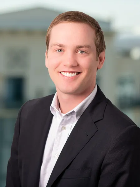 a man in a suit smiling