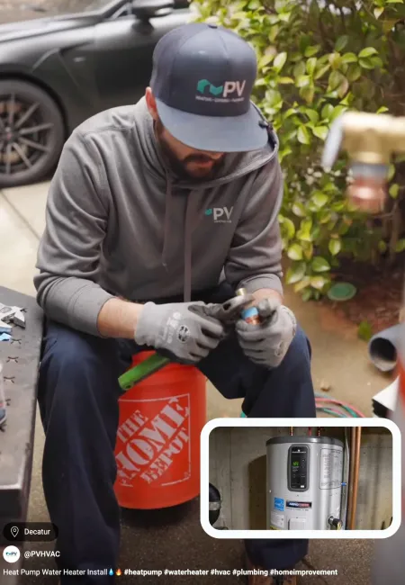 Technician installing a heat pump water heater in a residential setting.