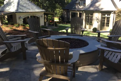 lawn chairs around a fire pit