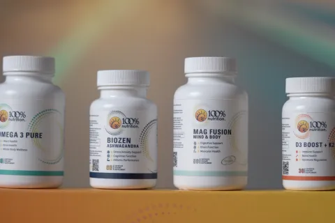 Four 100% Nutrition supplement bottles including Omega 3 Pure, BioZen Ashwagandha, Mag Fusion, and D3 Boost + K2 on a yellow box.