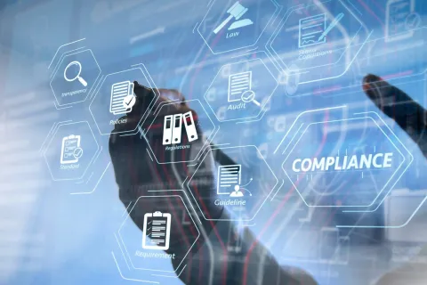 Hand interacting with virtual screen displaying compliance, policies, audit, and regulations icons in digital interface.