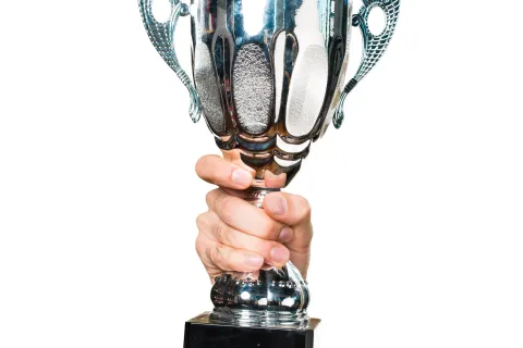 a hand holding a trophy