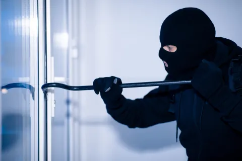 a thief breaking into a house