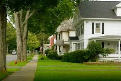 a white house with trees and grass