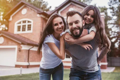a family in front of a house