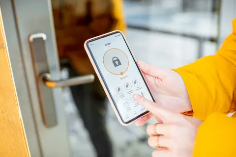 a person controlling cameras with a phone
