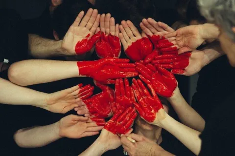 a group of hands designing a heart