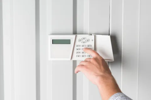 a hand setting up a thermostat
