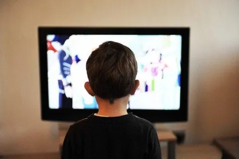 a boy watching a tv