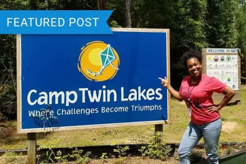 a person pointing at a sign
