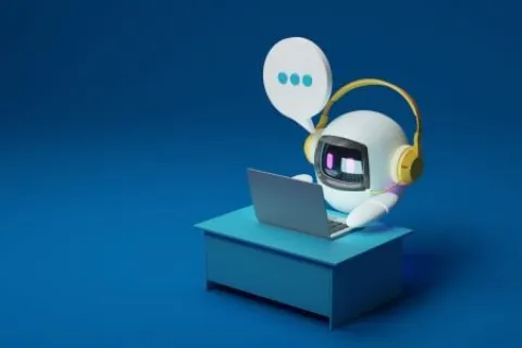 Cute robot with yellow headphones typing on a laptop at a blue desk with a speech bubble on blue background