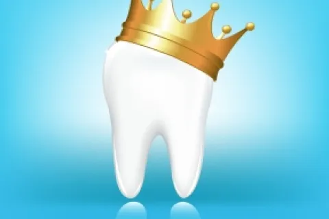 A smiling tooth crowned with a golden crown against a bright blue background.