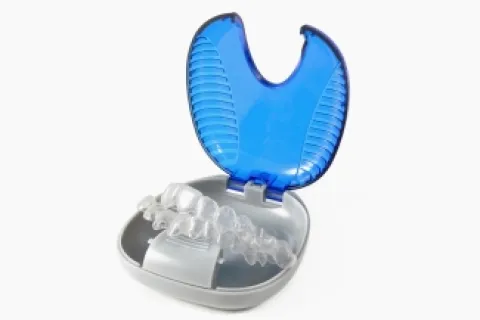 Orthodontic teeth aligner case with clear aligners neatly arranged inside.