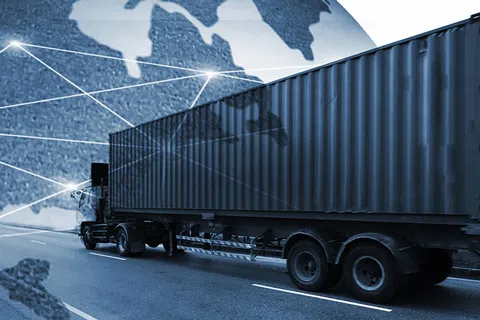 Large freight truck with container driving on road and global network connections overlay representing international shipping.