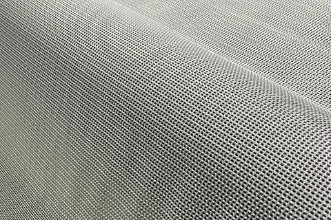 Close-up of a fine metal mesh fabric showcasing a woven grid pattern with a silver-gray finish.