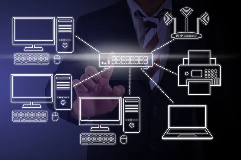 Businessman interacting with digital network diagram showing computers, router, printer, and laptop connections.