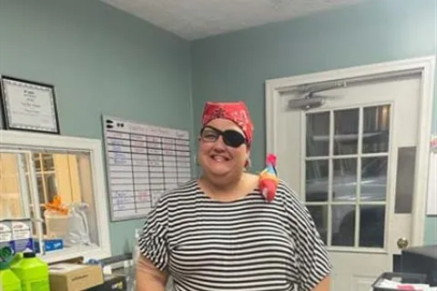 Pat Hurst wearing a hat and sunglasses