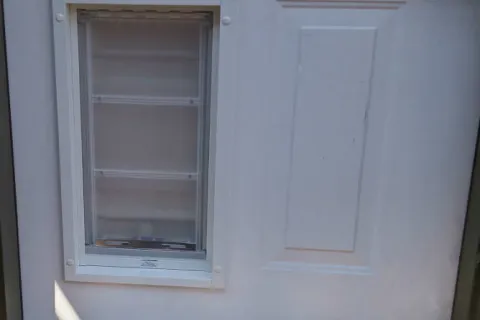 a white wall with a window