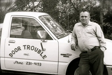a man standing next to a car