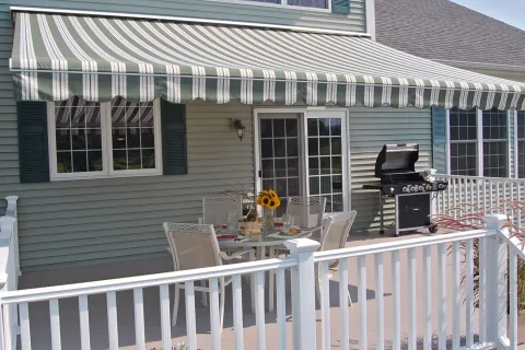 a house with a deck and a table and chairs