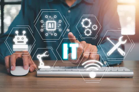 Person using computer with floating icons representing AI, robotics, IT, and technology services