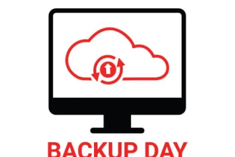 Computer screen with cloud backup icon and text World Backup Day March 31 highlighting data protection.