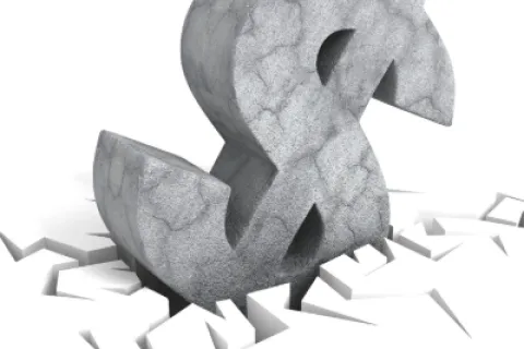 Large cracked stone dollar symbol breaking through cracked white surface, symbolizing financial impact.