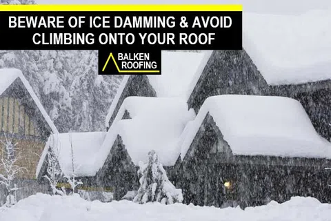 Snow-covered roofs in a heavy snowfall warning against ice damming and roof climbing by Balken Roofing.