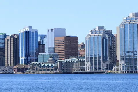 Halifax city skyline with modern skyscrapers and waterfront views under a clear blue sky.