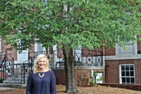 Caroline Pemberton standing in front of a building