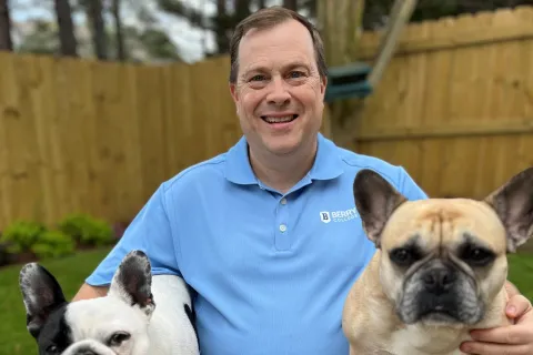 a person holding two dogs