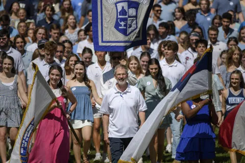 a crowd of people holding flags