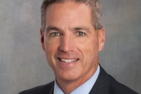 a man in a suit smiling