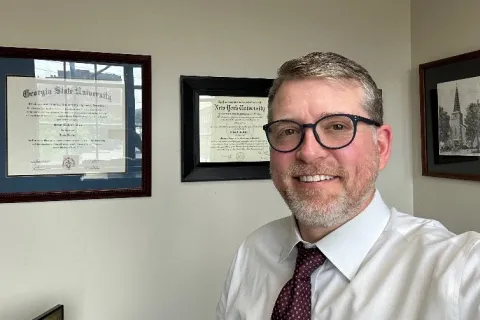 a man wearing glasses and a tie
