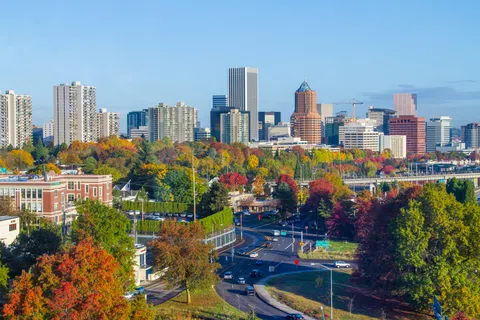 Portland city skyline with autumn trees and busy roads under a clear blue sky during daytime