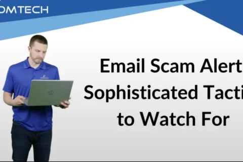 A man in a blue shirt using a laptop, discussing email scam alerts and tactics.