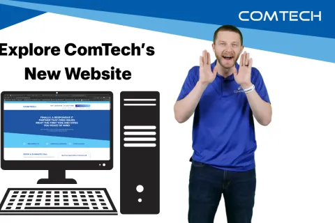 Person showcasing ComTech's new website on a computer screen with a desktop setup.