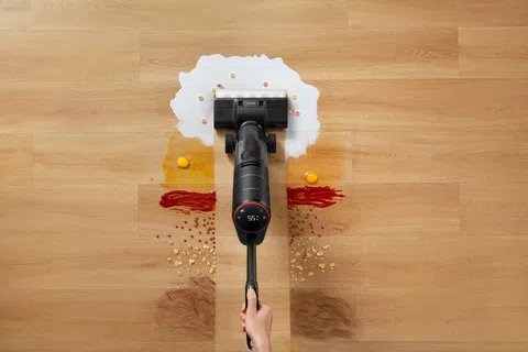 Vacuum cleaner effectively cleaning spilled milk, eggs, ketchup, cereal, and powder from hardwood floor.
